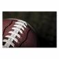 Preview: Nahaufnahme eines braunen American Footballs mit weißen Nähten.
