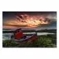 Preview: Ein verlassenes, rotes Boot liegt am Ufer, im Hintergrund ein farbenfroher Himmel. Preview: Ein verlassenes, rotes Boot liegt am Ufer, im Hintergrund ein farbenfroher Himmel.