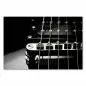 Preview: Schwarzweißfotografie der Brücke einer E-Gitarre mit fokussierten Saiten im Vordergrund. Preview: Schwarzweißfotografie der Brücke einer E-Gitarre mit fokussierten Saiten im Vordergrund.