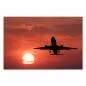 Preview: Flugzeug hebt vor rotem Himmel mit untergehender Sonne ab. Preview: Flugzeug hebt vor rotem Himmel mit untergehender Sonne ab.
