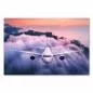 Preview: Flugzeug fliegt bei Sonnenuntergang über malerische Landschaft mit Bergen & Meer. Preview: Flugzeug fliegt bei Sonnenuntergang über malerische Landschaft mit Bergen & Meer.