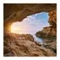 Preview: Blick aus Höhle auf Meer, Sonnenaufgang, warme Farben spiegeln sich im Wasser. Preview: Blick aus Höhle auf Meer, Sonnenaufgang, warme Farben spiegeln sich im Wasser.