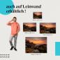 Preview: Dramatischer Sonnenuntergang an felsiger Küste mit Palmen als Leinwandbild.