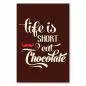 Preview: Brauner Hintergrund mit Schriftzug "Life is Short Eat Chocolate" und rotem Schnurrbart. Preview: Brauner Hintergrund mit Schriftzug "Life is Short Eat Chocolate" und rotem Schnurrbart.