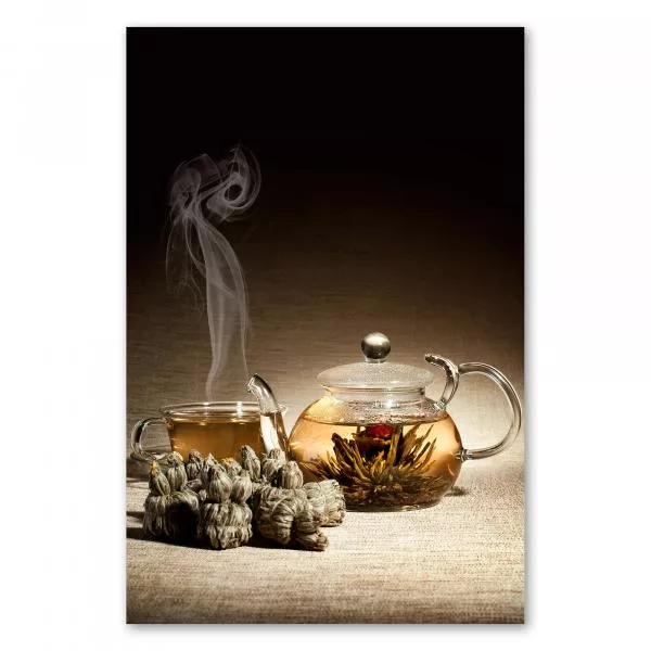 Eine Glasteekanne mit blühendem Tee und eine Tasse dampfenden Tees stehen bereit. Der Duft des Tees und die zarten Blüten versprechen einen Moment der Entspannung und des Genusses. Eine Glasteekanne mit blühendem Tee und eine Tasse dampfenden Tees stehen bereit. Der Duft des Tees und die zarten Blüten versprechen einen Moment der Entspannung und des Genusses.